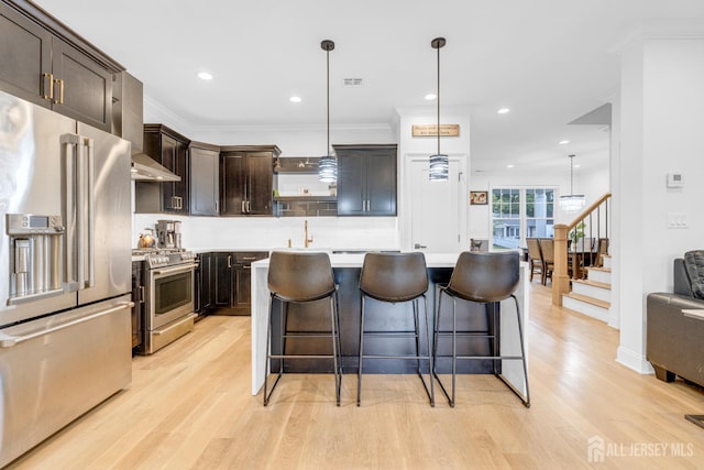 40 Cambridge Rd, Edison, NJ 08817 - kitchen with stainless steel appliances, light wood finished floors, dark brown cabinets, light countertops, and backsplash
