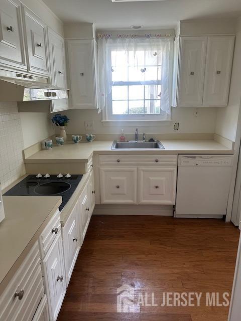 71 Rossmoor Dr Unit B, Monroe, NJ 08831 - kitchen with dishwasher, a sink, under cabinet range hood, and white cabinetry