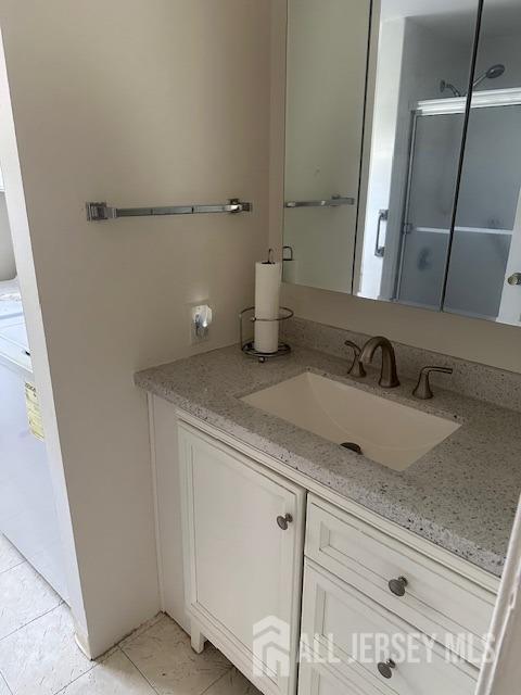 71 Rossmoor Dr Unit B, Monroe, NJ 08831 - bathroom with vanity and tile patterned flooring