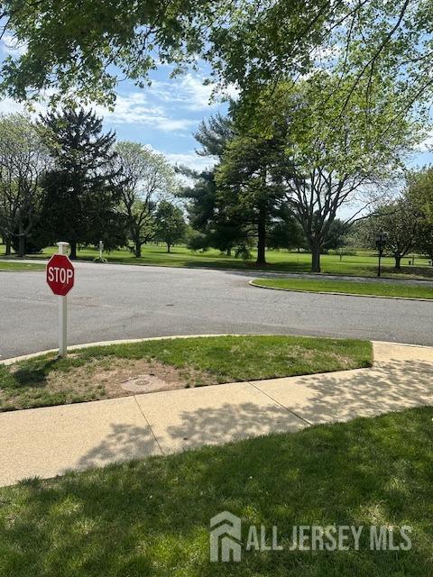 71 Rossmoor Dr Unit B, Monroe, NJ 08831 - view of asphalt street with traffic signs and sidewalks