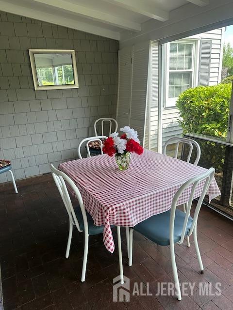 71 Rossmoor Dr Unit B, Monroe, NJ 08831 - dining room with beamed ceiling and concrete block wall