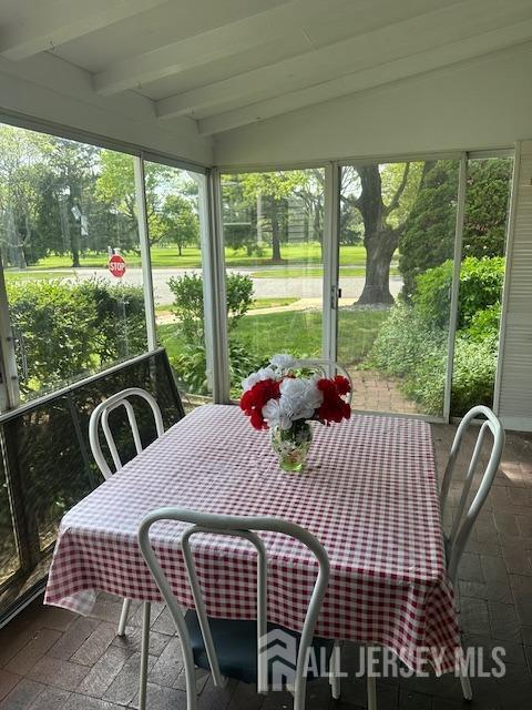 71 Rossmoor Dr Unit B, Monroe, NJ 08831 - sunroom / solarium with beam ceiling and outdoor dining space