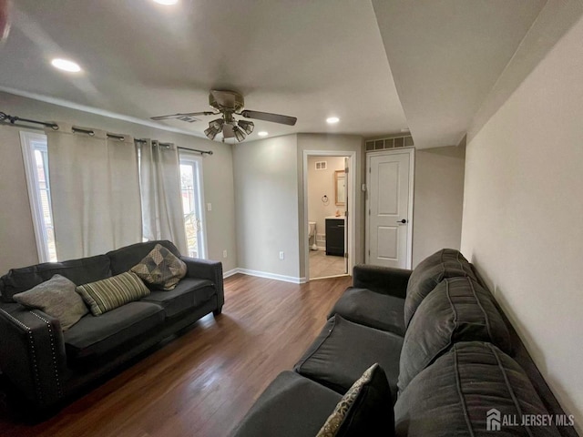 living room featuring recessed lighting, wood finished floors, visible vents, a ceiling fan, and baseboards