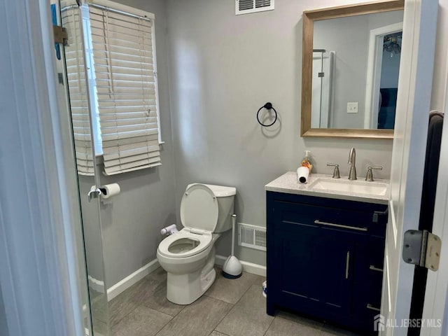 bathroom with visible vents, toilet, baseboards, and vanity