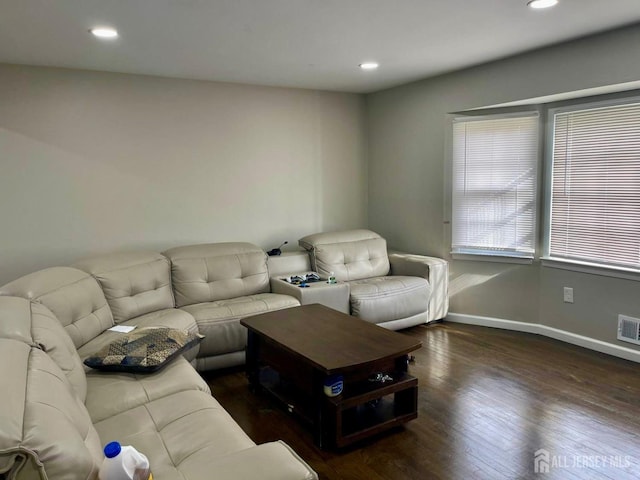 living area with hardwood / wood-style floors, baseboards, recessed lighting, and visible vents