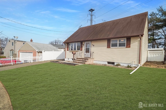 view of front facade with a garage, a front yard, and fence