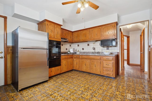 kitchen featuring decorative backsplash, a warming drawer, freestanding refrigerator, and oven