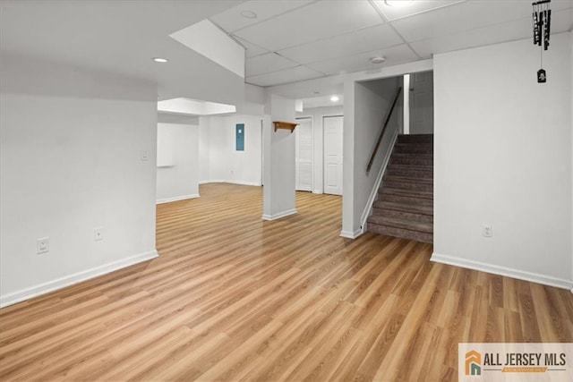 124 Kingsland Cir S, Brunswick, NJ 08852 - finished below grade area featuring a paneled ceiling, stairs, light wood finished floors, and recessed lighting