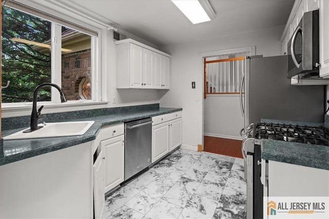 124 Kingsland Cir S, Brunswick, NJ 08852 - kitchen with appliances with stainless steel finishes, light marble finish floors, white cabinets, and dark countertops