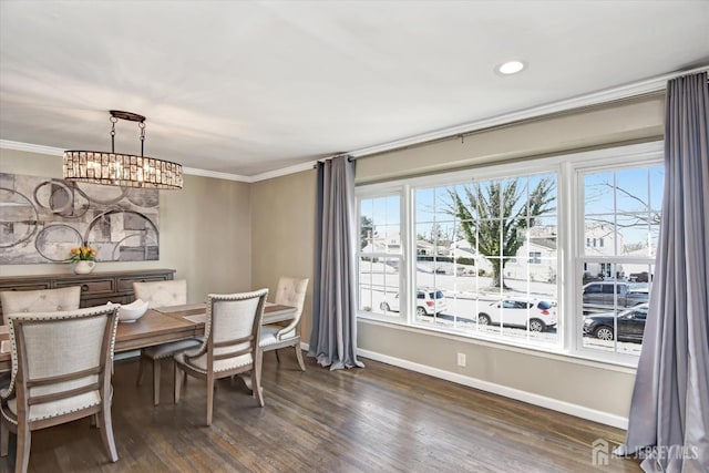 dining space with a chandelier, crown molding, and dark hardwood / wood-style floors