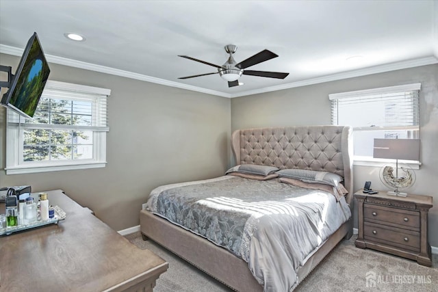 carpeted bedroom featuring ceiling fan and ornamental molding