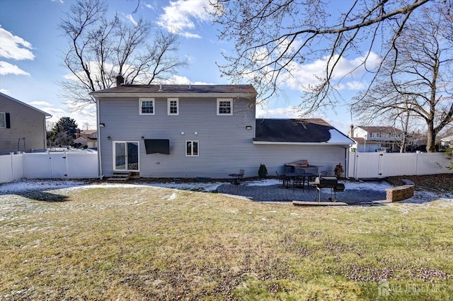 rear view of house with a patio area and a lawn