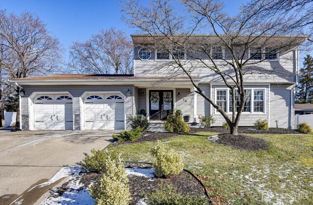 front of property with a garage and a front lawn