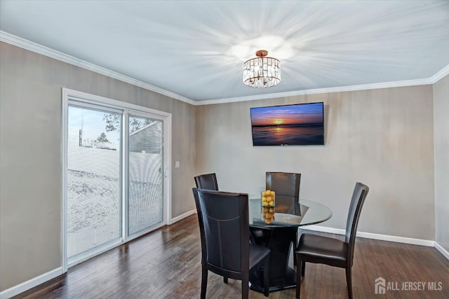 dining area with dark hardwood / wood-style flooring, a notable chandelier, and ornamental molding