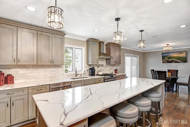 kitchen featuring a kitchen island, decorative light fixtures, wall chimney range hood, and tasteful backsplash