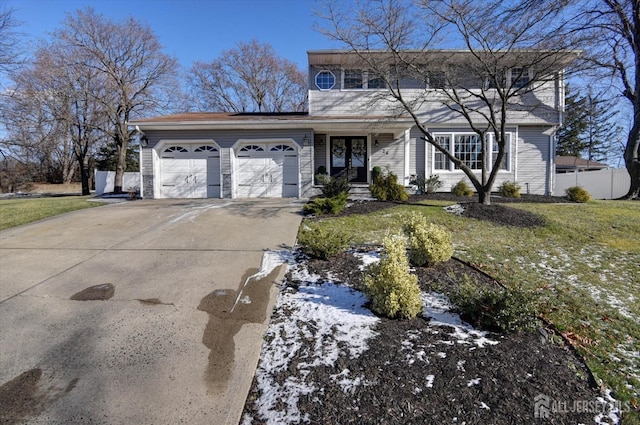 front facade featuring a lawn and a garage