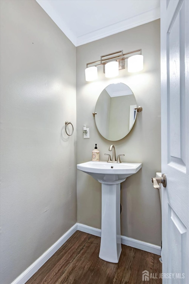 bathroom featuring hardwood / wood-style flooring and ornamental molding