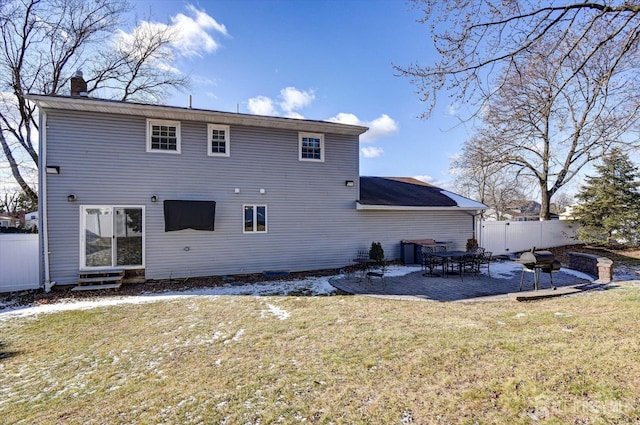 back of house featuring a patio area and a lawn