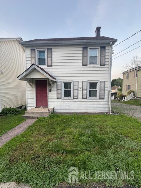 17 Grant St, Dover, NJ 07801 - traditional home with a chimney and a front yard