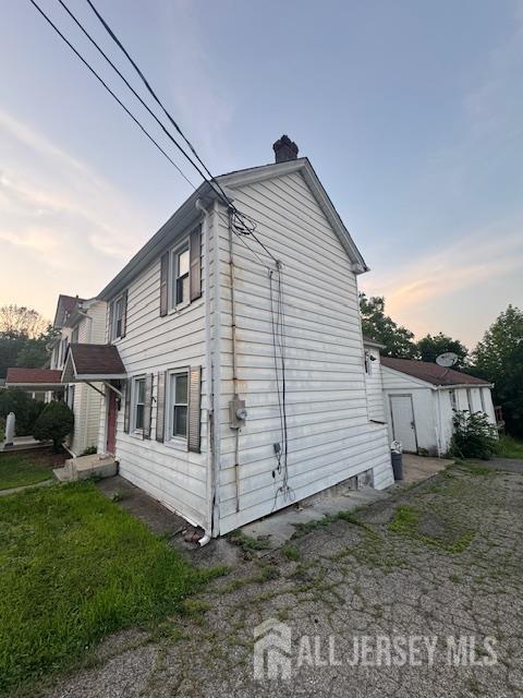 17 Grant St, Dover, NJ 07801 - property exterior at dusk featuring a chimney