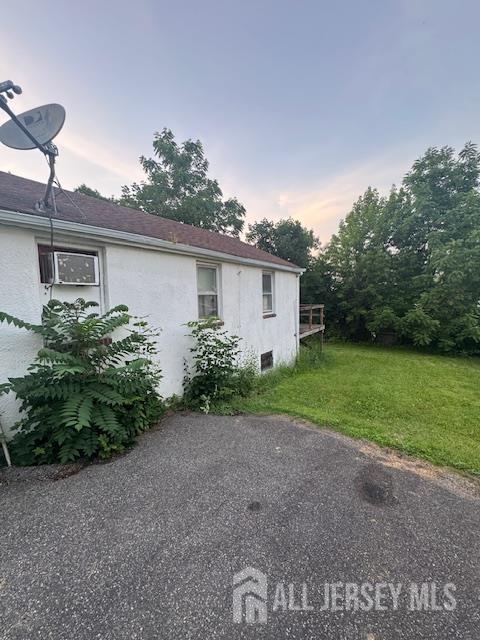 17 Grant St, Dover, NJ 07801 - view of side of home with stucco siding and a yard
