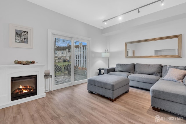 806 Darlington Dr, Old Bridge, NJ 08857 - living room featuring rail lighting, light wood finished floors, and a glass covered fireplace