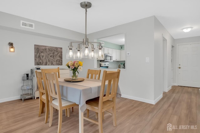 806 Darlington Dr, Old Bridge, NJ 08857 - dining area with light wood-type flooring and a chandelier