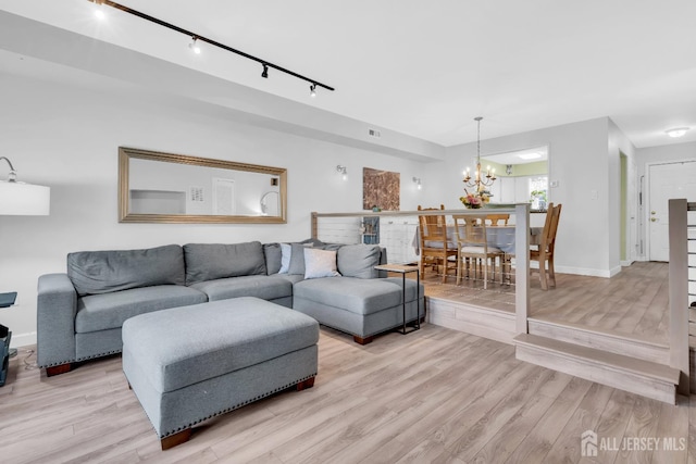 806 Darlington Dr, Old Bridge, NJ 08857 - living room featuring track lighting, a chandelier, and light wood-style floors