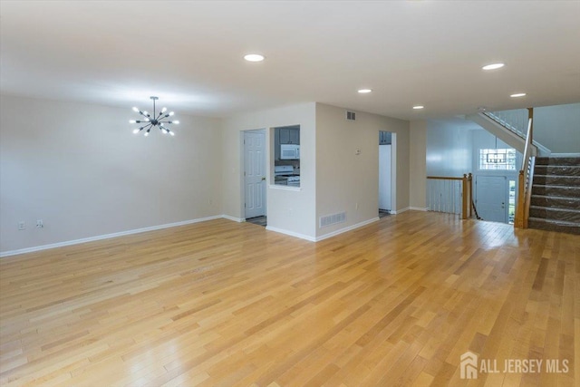 3 Rozalyn Ln, Old Bridge, NJ 08879 - unfurnished living room featuring recessed lighting, light wood-style flooring, a chandelier, and stairway