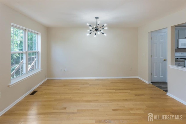 3 Rozalyn Ln, Old Bridge, NJ 08879 - unfurnished dining area with a chandelier and light wood finished floors