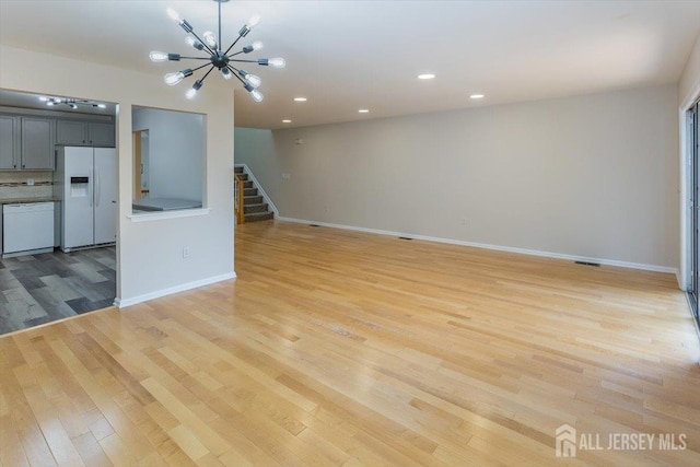3 Rozalyn Ln, Old Bridge, NJ 08879 - unfurnished living room featuring light wood finished floors, stairway, a chandelier, and recessed lighting