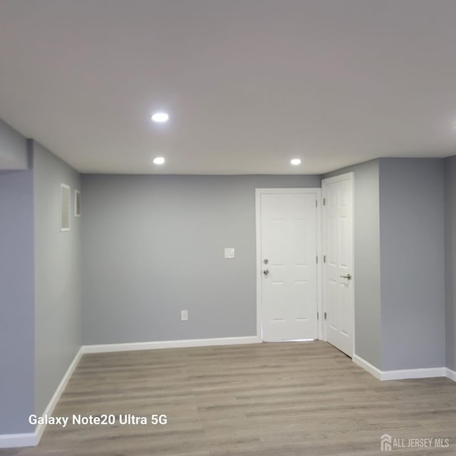 basement with light hardwood / wood-style floors