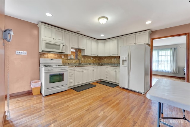 77 Manhattan Ave, Avenel, NJ 07001 - kitchen with white appliances, light wood-style flooring, tasteful backsplash, recessed lighting, and white cabinets
