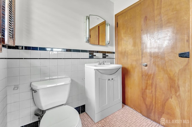 77 Manhattan Ave, Avenel, NJ 07001 - half bathroom featuring vanity, wainscoting, and tile walls