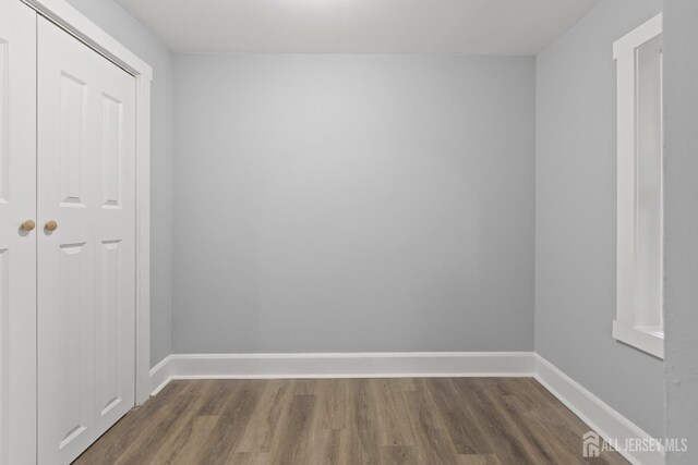 empty room with dark hardwood / wood-style floors