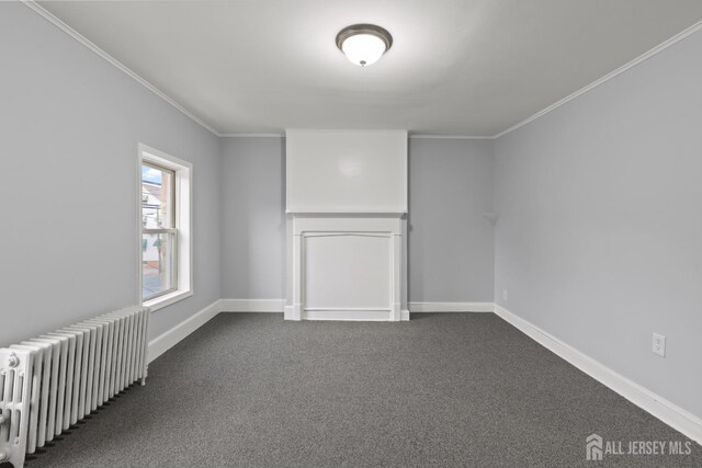 carpeted empty room featuring radiator heating unit and ornamental molding