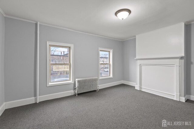 carpeted empty room featuring radiator and crown molding