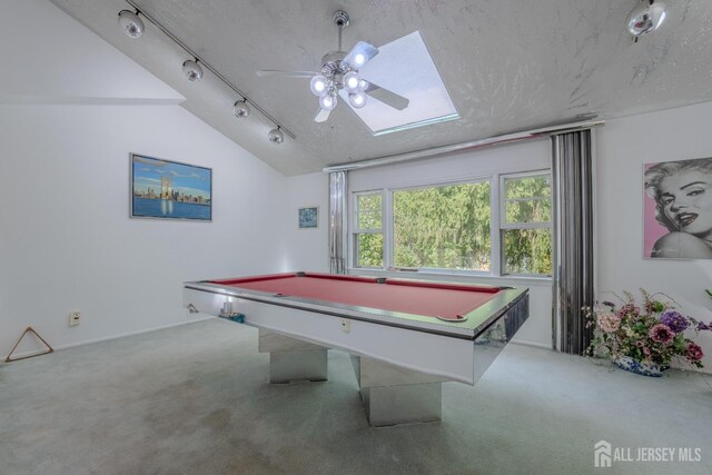 game room with carpet flooring, lofted ceiling, a skylight, ceiling fan, and billiards