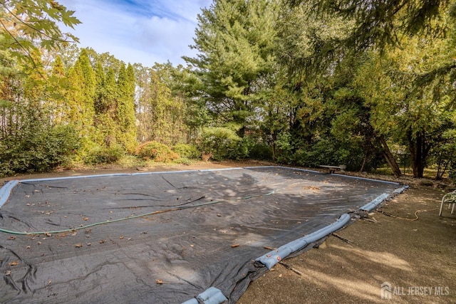 view of pool featuring a forest view