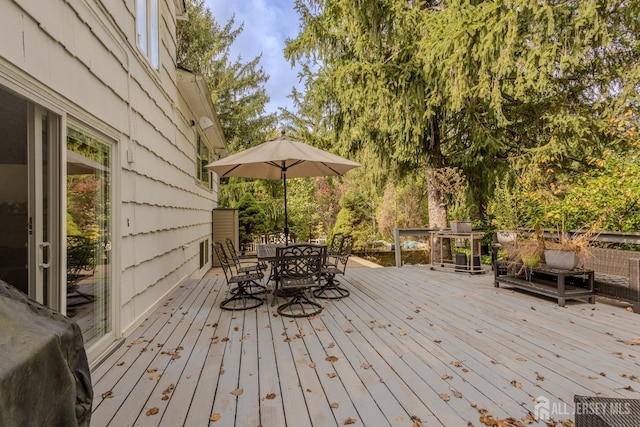 wooden terrace featuring outdoor dining space