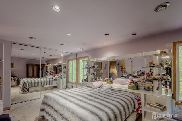 bedroom featuring recessed lighting, carpet floors, and a closet