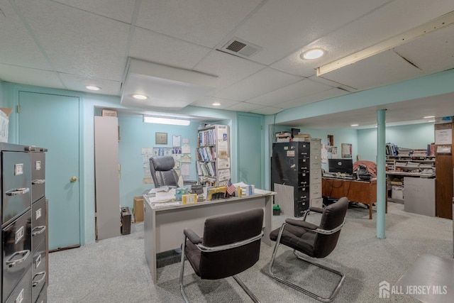office space featuring a paneled ceiling and light carpet