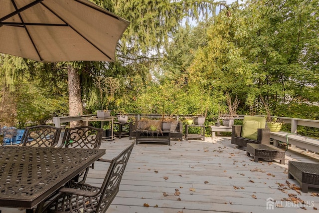 wooden deck with an outdoor living space and outdoor dining area