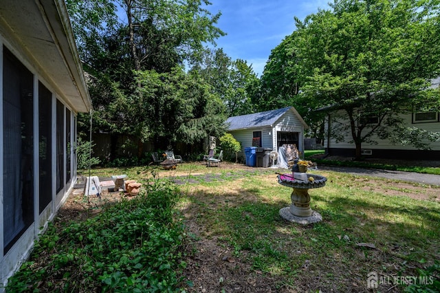 570 Main St, Metuchen, NJ 08840 - view of grassy yard with a garage and a storage shed