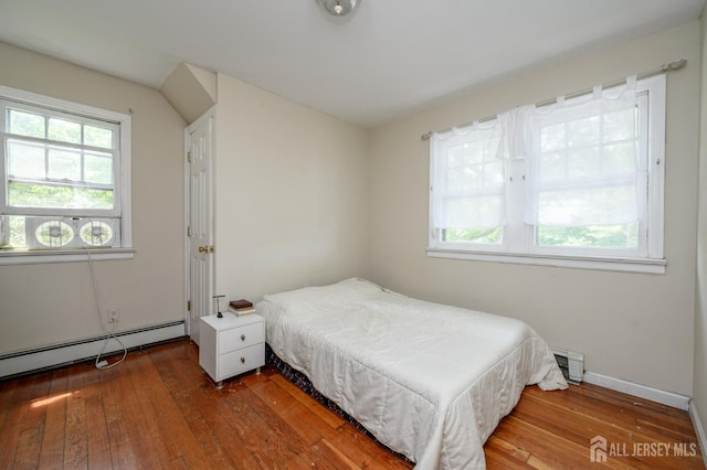 570 Main St, Metuchen, NJ 08840 - bedroom with hardwood / wood-style flooring, baseboard heating, and a baseboard radiator