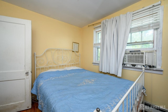570 Main St, Metuchen, NJ 08840 - bedroom featuring baseboard heating, cooling unit, and wood finished floors