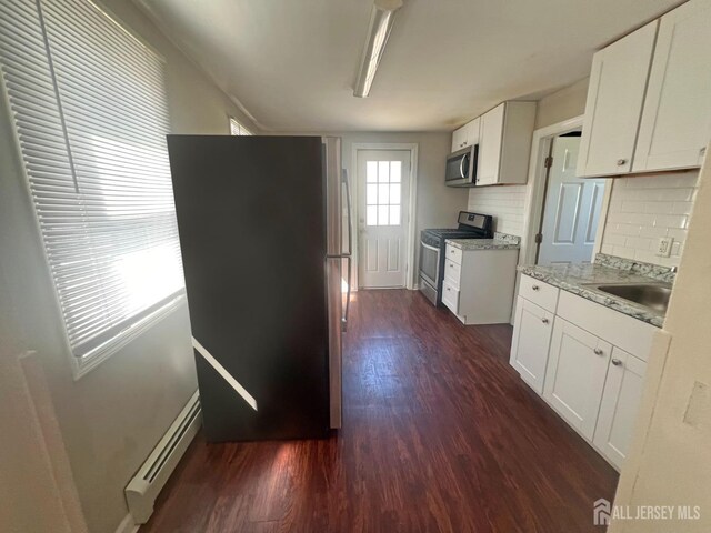865 Kreil St, Perth Amboy, NJ 08861 - kitchen with stainless steel appliances, a baseboard radiator, a sink, dark wood-style floors, and baseboards