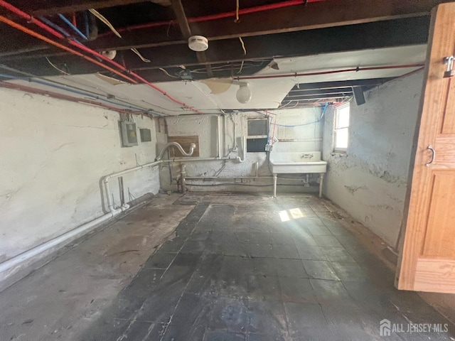 865 Kreil St, Perth Amboy, NJ 08861 - basement with electric panel and a sink