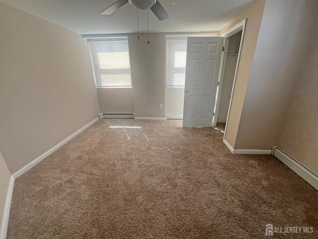 865 Kreil St, Perth Amboy, NJ 08861 - unfurnished bedroom featuring a baseboard heating unit, light carpet, baseboards, and ceiling fan