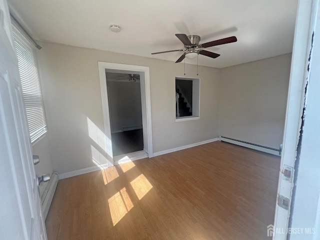 865 Kreil St, Perth Amboy, NJ 08861 - unfurnished bedroom featuring a baseboard heating unit, light wood finished floors, baseboards, and baseboard heating